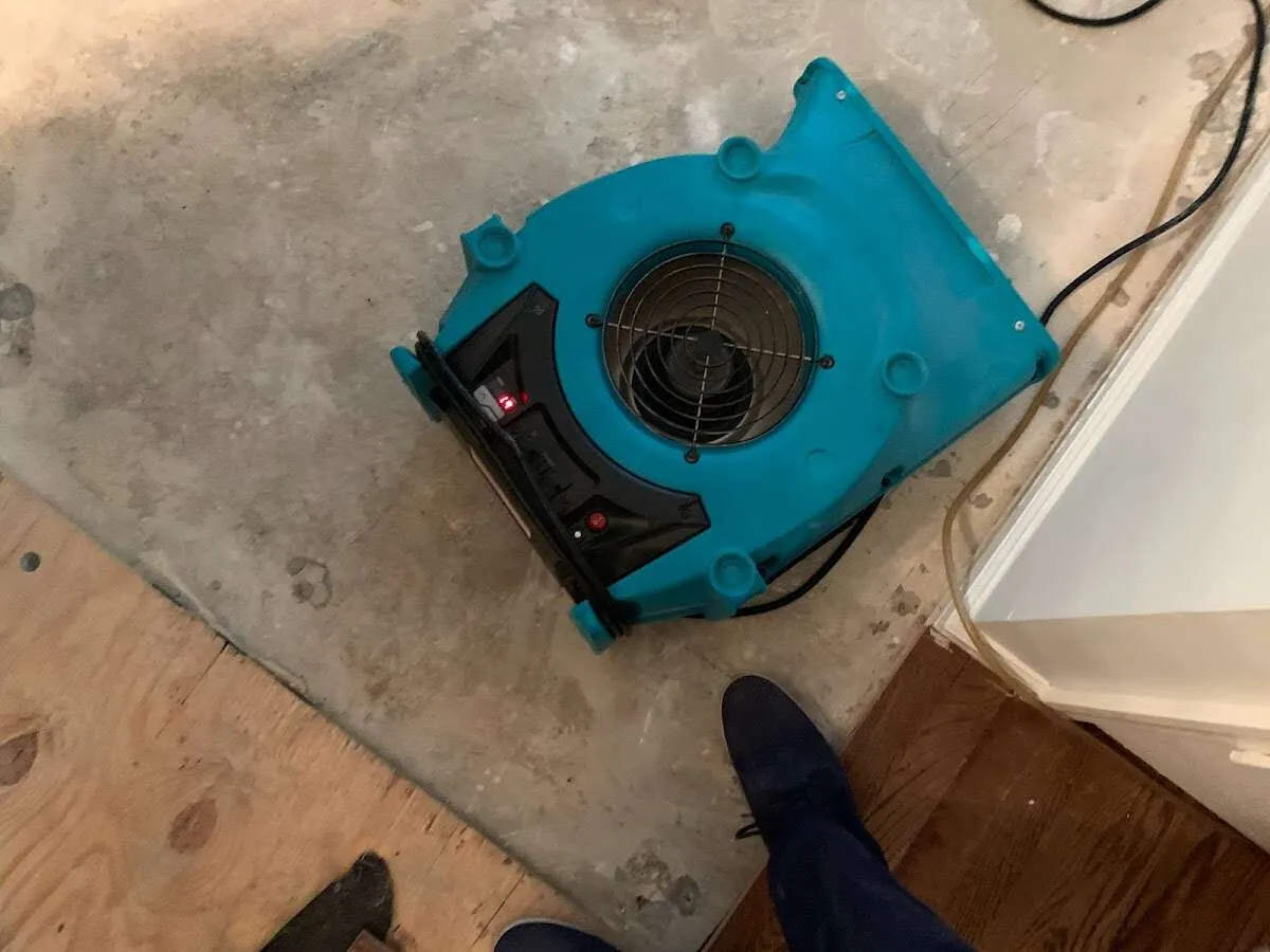 Air mover drying subfloor during Commercial Water Damage Restoration in Millville